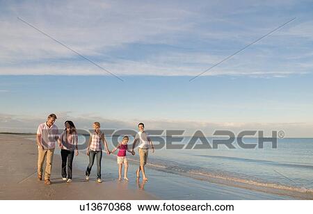 Family walking together on beach View Large Photo Image Stock Photo - Family walking together on beach. Fotosearch