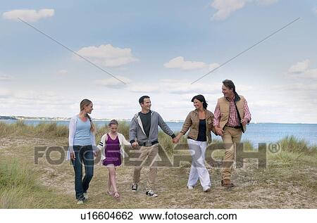 Stock Image - Family walking together outdoors. Fotosearch