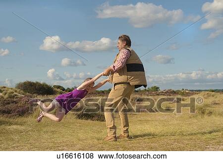 Father and daughter playing outdoors View Large Photo Image Stock Photo - Father and daughter playing outdoors. Fotosearch