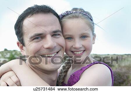 Picture - Father and daughter smiling together. Fotosearch