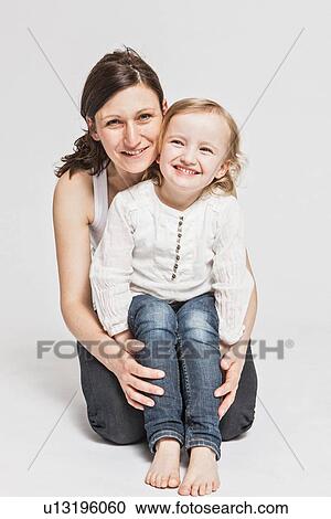 Stock Image - Father and daughter smiling together. Fotosearch