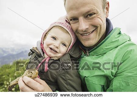 Father holding daughter outdoors View Large Photo Image Stock Photo - Father holding daughter outdoors. Fotosearch