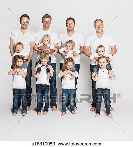 Stock Image - Fathers and children posing together. Fotosearch