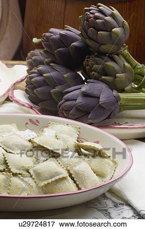 Fresh pasta with cheese and artichokes View Large Photo Image Stock Photo - Fresh pasta with cheese and artichokes. Fotosearch