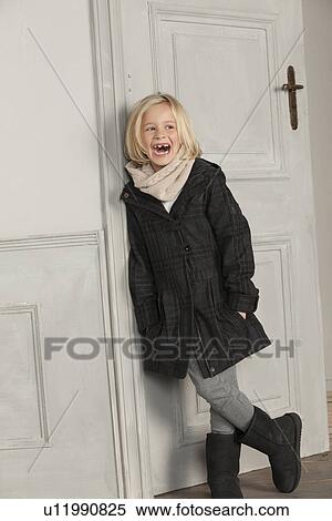 Girl in winter coat and scarf indoors View Large Photo Image Stock Photography - Girl in winter coat and scarf indoors. Fotosearch