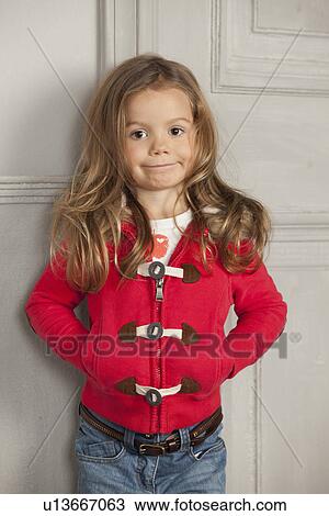 Stock Image - Girl leaning against door. Fotosearch