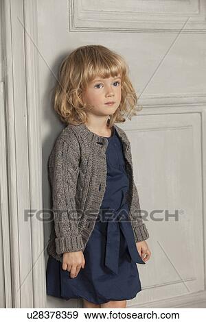 Girl leaning against door View Large Photo Image Stock Photo - Girl leaning against door. Fotosearch