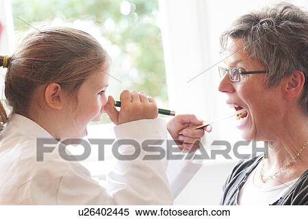Girl playing doctor with grandmother View Large Photo Image Stock Photography - Girl playing doctor with grandmother. Fotosearch