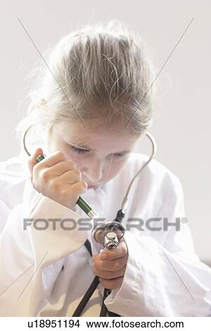 Girl playing doctor with stethoscope View Large Photo Image Picture - Girl playing doctor with stethoscope. Fotosearch