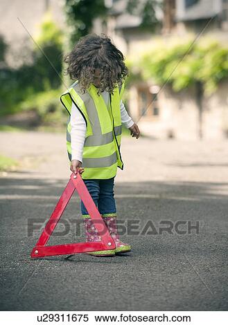 Girl playing traffic worker on rural road View Large Photo Image Stock Photography - Girl playing traffic worker on rural road. Fotosearch