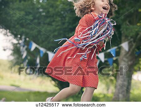 Girl playing with ribbons outdoors View Large Photo Image Stock Photo - Girl playing with ribbons outdoors. Fotosearch