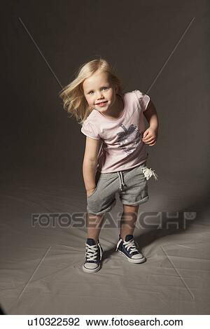 Girl smiling in studio View Large Photo Image Stock Image - Girl smiling in studio. Fotosearch