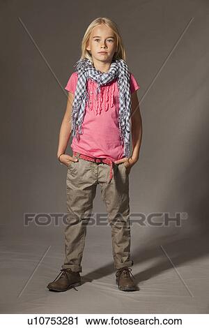 Girl standing in studio View Large Photo Image Stock Image - Girl standing in studio. Fotosearch