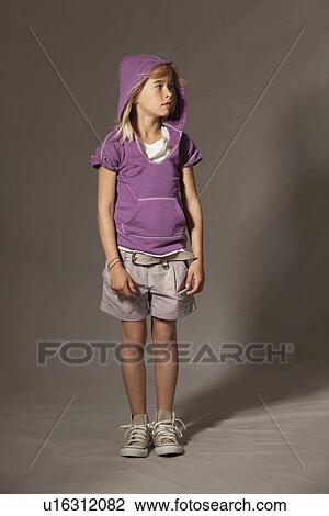 Girl standing in studio View Large Photo Image Stock Image - Girl standing in studio. Fotosearch
