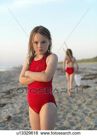 Girl standing on sandy beach View Large Photo Image Stock Photo - Girl standing on sandy beach. Fotosearch