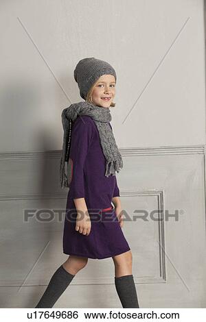 Girl wearing scarf and hat indoors View Large Photo Image Stock Photograph - Girl wearing scarf and hat indoors. Fotosearch