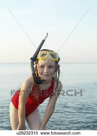 Stock Photography - Girl wearing snorkel and mask in water. Fotosearch