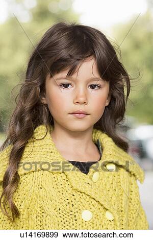 Stock Photo - Girl wearing yellow sweater outdoors. Fotosearch