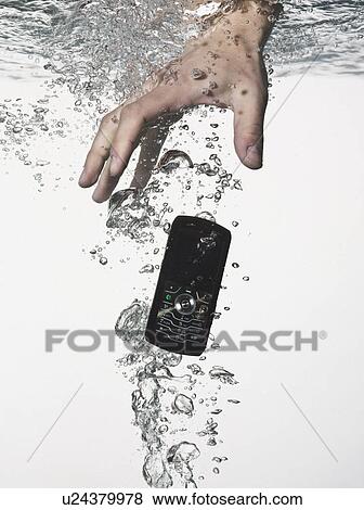 Stock Photo - Hand grasping cell phone in water. Fotosearch