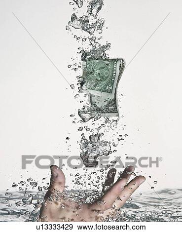 Stock Photo - Hand grasping dollar bill in water. Fotosearch