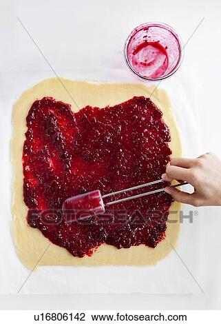 Hand spreading jam on dough View Large Photo Image Stock Image - Hand spreading jam on dough. Fotosearch