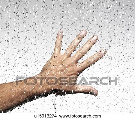 Hand thrust into falling water drops View Large Photo Image Picture - Hand thrust into falling water drops. Fotosearch