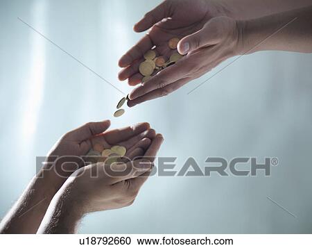 Hands passing pile of coins View Large Photo Image Stock Image - Hands passing pile of coins. Fotosearch