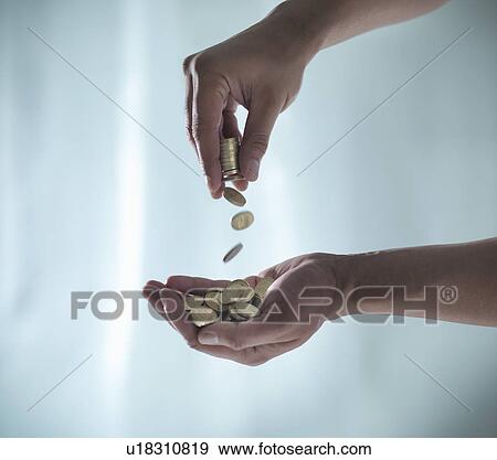 Hands playing with pile of coins View Large Photo Image Stock Photo - Hands playing with pile of coins. Fotosearch