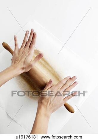 Hands rolling dough on counter View Large Photo Image Stock Image - Hands rolling dough on counter. Fotosearch