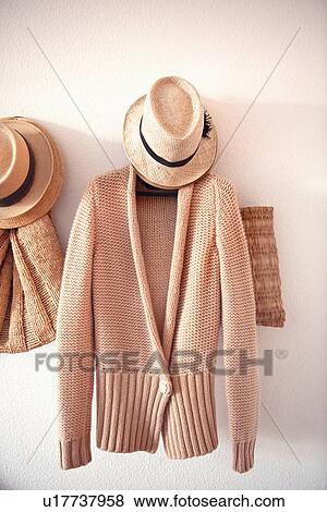 Stock Photo - Knitted sweater and hat on hook. Fotosearch