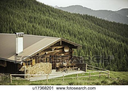 Log cabin on grassy hillside View Large Photo Image Stock Image - Log cabin on grassy hillside. Fotosearch