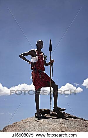 Maasai man standing on top of rock View Large Photo Image Stock Photography - Maasai man standing on top of rock. Fotosearch