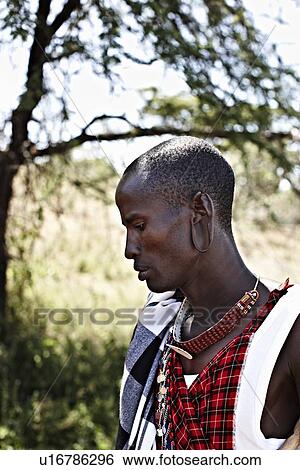 Stock Photograph - Maasai man standing outdoors. Fotosearch