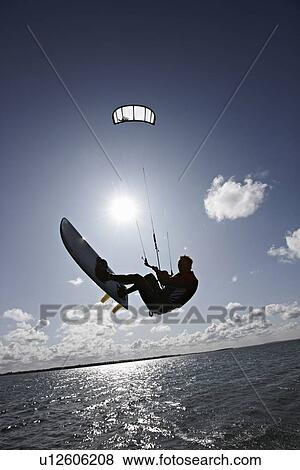 Man kite surfing on calm water View Large Photo Image Stock Photo - Man kite surfing on calm water. Fotosearch
