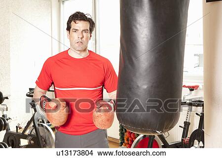 Man using punching bag at gym View Large Photo Image Picture - Man using punching bag at gym. Fotosearch