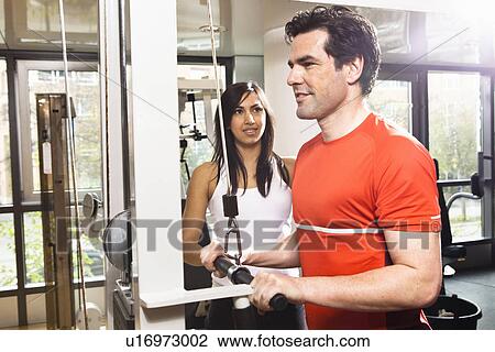 Man working with trainer at gym View Large Photo Image Stock Image - Man working with trainer at gym. Fotosearch