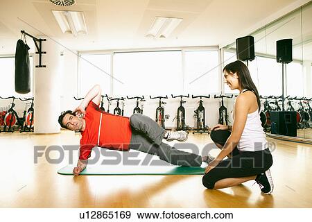 Man working with trainer at gym View Large Photo Image Stock Photo - Man working with trainer at gym. Fotosearch
