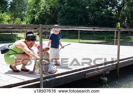 Mother and children examining river View Large Photo Image Stock Photograph - Mother and children examining river. Fotosearch