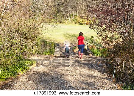 Mother and daughter gardening together View Large Photo Image Stock Image - Mother and daughter gardening together. Fotosearch