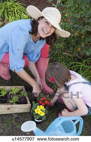 Stock Photo - Mother and daughter gardening together. Fotosearch