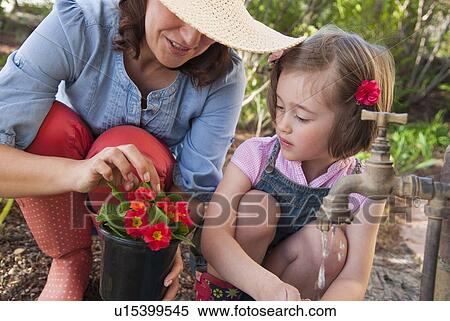 Mother and daughter gardening together View Large Photo Image Stock Photography - Mother and daughter gardening together. Fotosearch