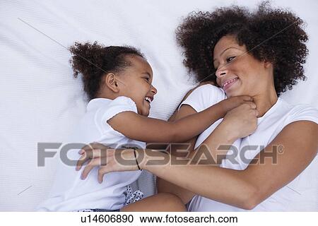Mother and daughter playing together View Large Photo Image Stock Image - Mother and daughter playing together. Fotosearch