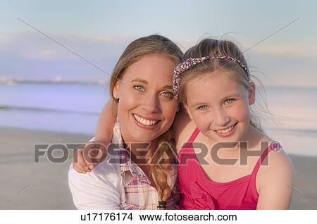 Picture - Mother and daughter smiling on beach. Fotosearch
