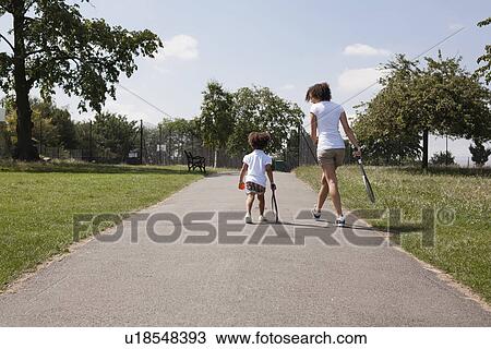 Stock Image - Mother and daughter with tennis rackets. Fotosearch