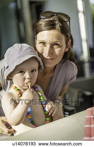Mother and son sitting together outdoors View Large Photo Image Stock Image - Mother and son sitting together outdoors. Fotosearch