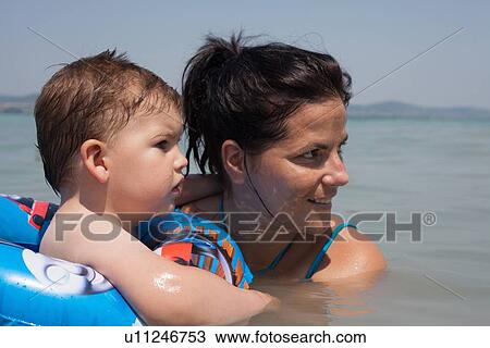 Mother and son swimming together View Large Photo Image Stock Image - Mother and son swimming together. Fotosearch