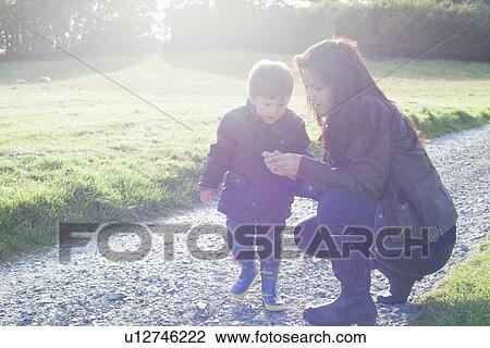 Mother and son talking on dirt road View Large Photo Image Stock Image - Mother and son talking on dirt road. Fotosearch