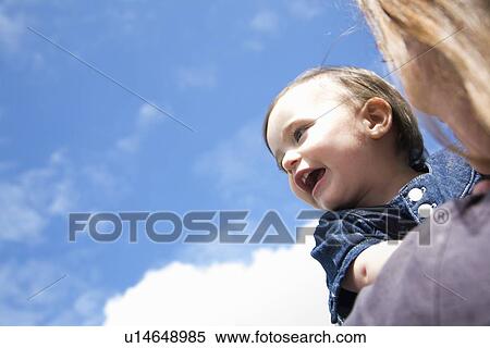 Mother carrying daughter outdoors View Large Photo Image Stock Photography - Mother carrying daughter outdoors. Fotosearch