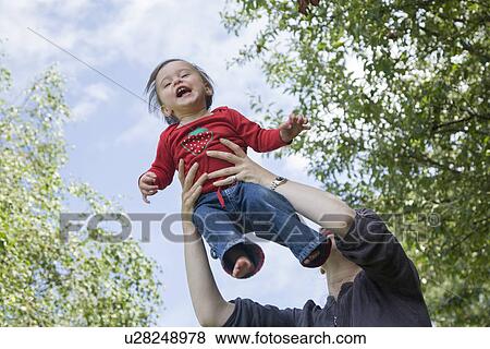 Mother playing with daughter outdoors View Large Photo Image Stock Photo - Mother playing with daughter outdoors. Fotosearch