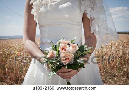 Newlywed bride holding bouquet View Large Photo Image Stock Image - Newlywed bride holding bouquet. Fotosearch